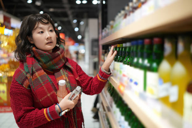 istock Young Girl Exploring Beverage Aisle in a Supermarket Setting 2194193817
