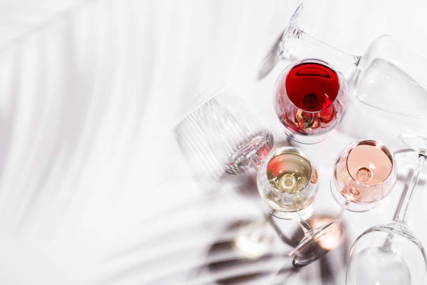 istock Three wine glasses filled with red, white, and rose wine 2194194030