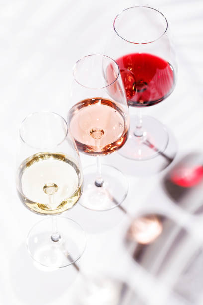 istock Three wine glasses filled with red, white, and rose wine 2194194039