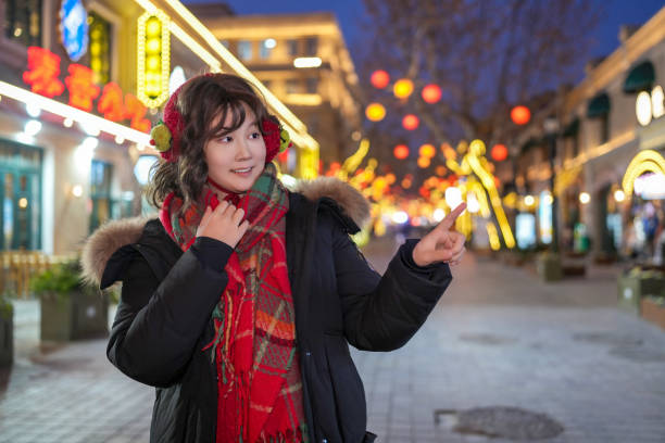 istock Young Woman Enjoys Evening Stroll Amidst Vibrant Lanterns 2194194068