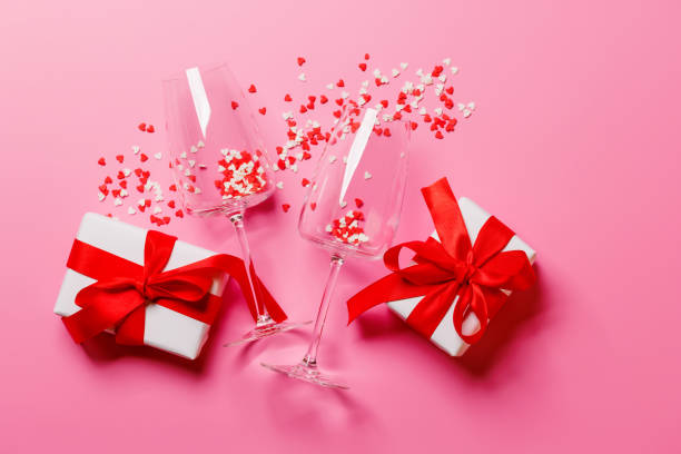 istock A champagne glasses adorned with heart-shaped decor on a vibrant pink background 2194194133