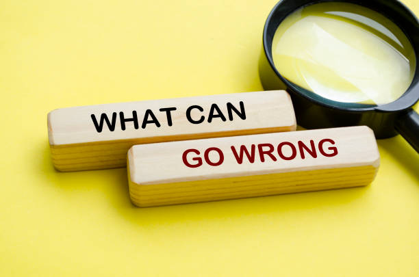 istock Side view of What Can Go Wrong text on wooden blocks with magnifying glass 2194195082