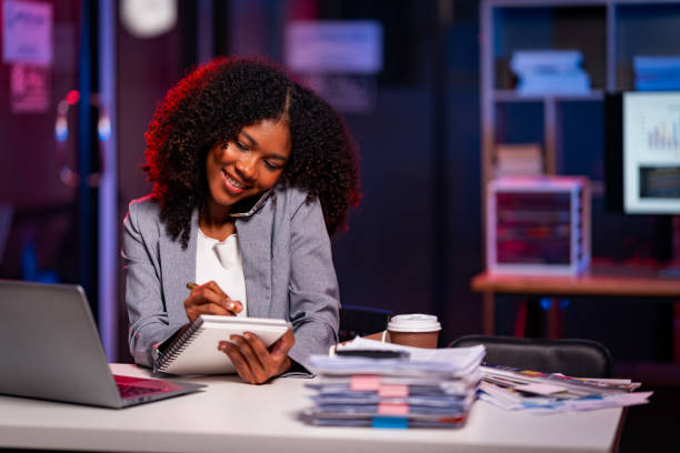 istock Young African woman talking on mobile phone Think about consulting conversations about customer support products in the office. 2194195431