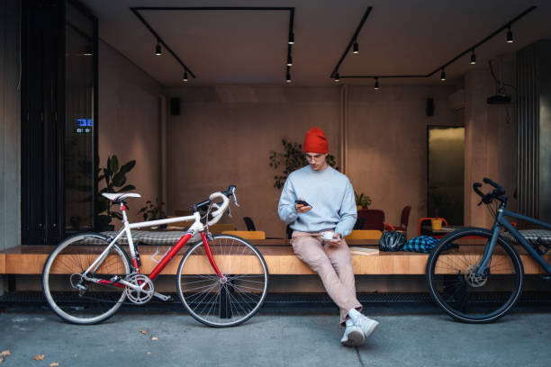 istock Man Relaxing Outside Cafe With Coffee and Bicycle 2194195439