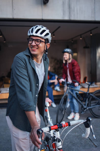 istock Young Adults with Bicycles Socializing Outside a Modern Cafe 2194195524