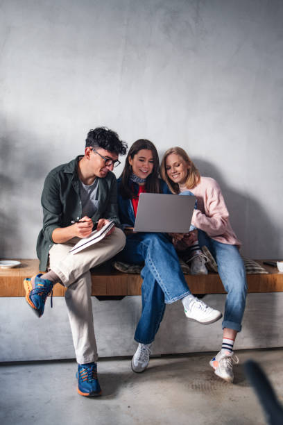 Group of Friends Collaborating on a Project in a Modern Setting