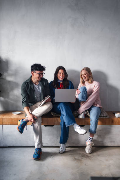 istock Group of Friends Sharing a Laptop While Enjoying Time Together 2194195530