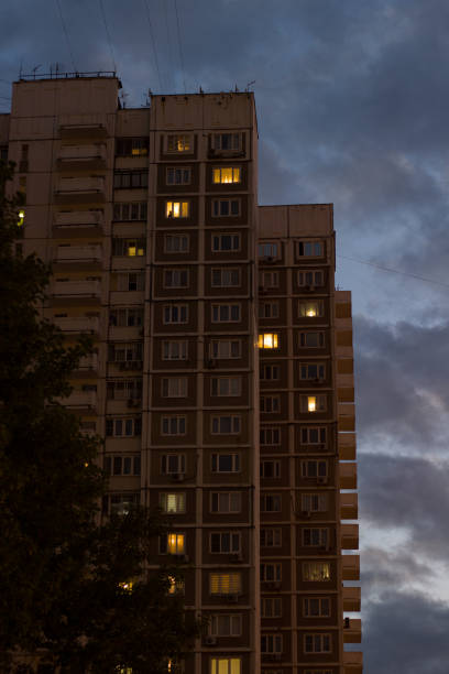 istock The facade of a Soviet multi-story building at dusk. The light in the windows burns comfortably and warmly. 2194196948