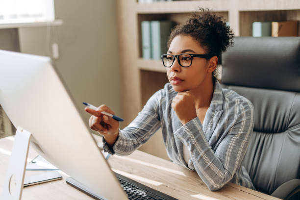 istock Focused African American businesswoman working on computer in modern office 2194199165