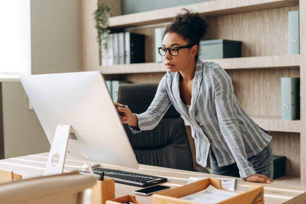 istock Focused businesswoman working on computer in modern office 2194199170