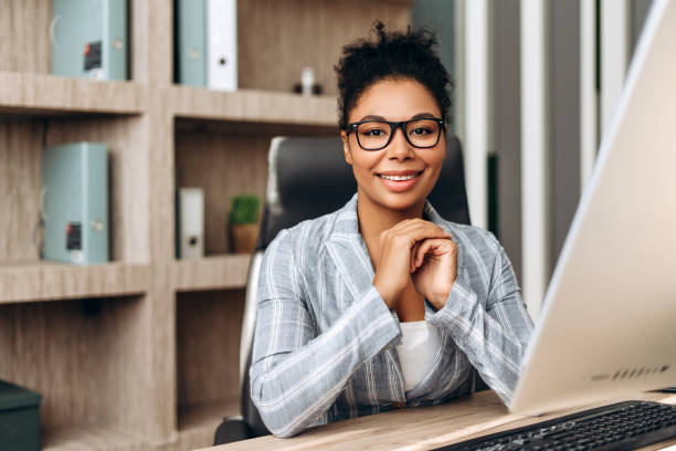 istock Smiling businesswoman working with computer in modern office 2194199217