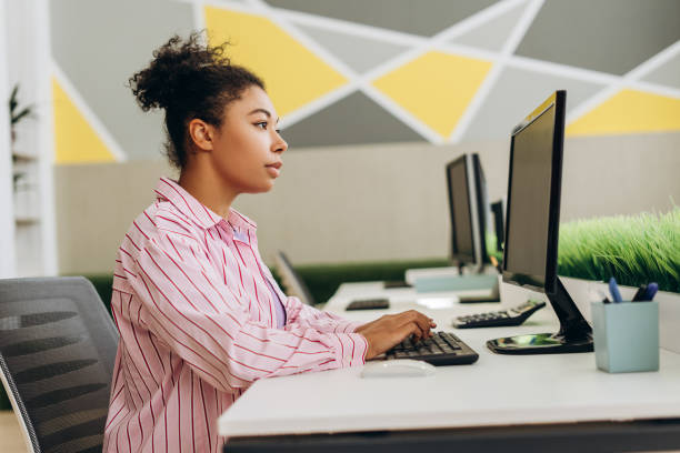 istock Focused employee typing on keyboard in modern office 2194199771
