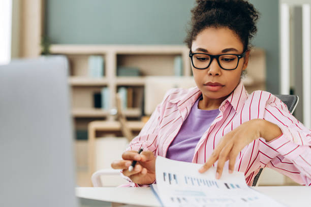 istock Focused accountant examining financial reports at home office desk 2194199815