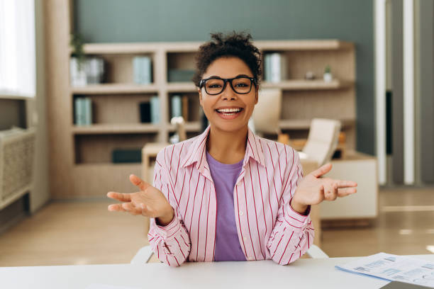 istock Smiling businesswoman making video call gesturing with hands at office desk 2194199848