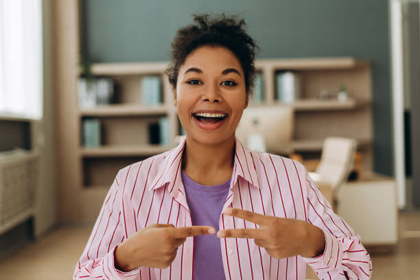 istock Excited young manager showing tiny size with fingers and smiling at camera 2194199858