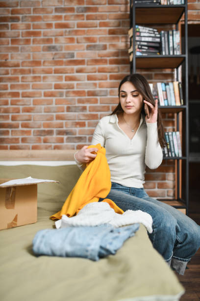 istock Female Talking on Phone With Sales Representative Complaining She Got Wrong Clothing Size 2194202417