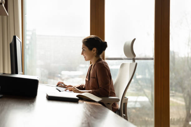 istock Side view confident Indian businesswoman working online in modern office 2194206586