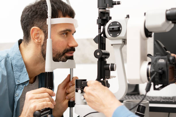 istock Optometrist examining patient's eyesight with slit lamp and camera in ophthalmology clinic 2194207076