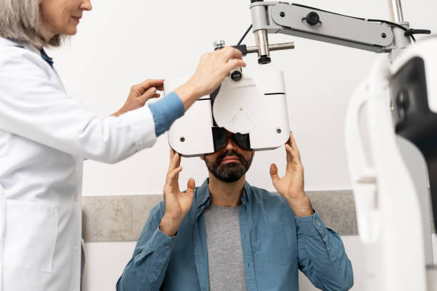 istock Optometrist examining patient's eyesight with phoropter in ophthalmology clinic 2194207091
