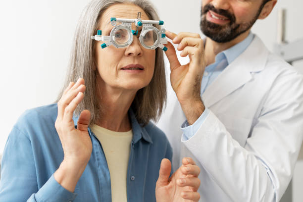istock Senior woman undergoing eye exam with phoropter by optometrist 2194207224