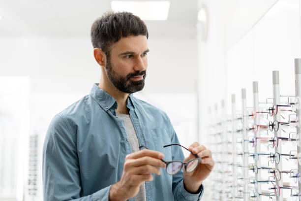 istock Bearded man choosing eyeglasses in optical store 2194207236