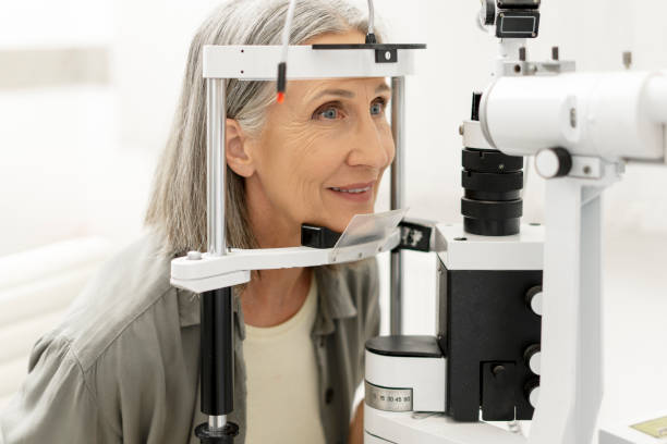 istock Senior woman undergoing eye exam using phoropter in ophthalmology clinic 2194207498