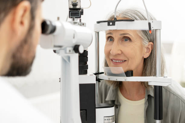 istock Senior woman undergoing eye exam with slit lamp by optometrist 2194207554