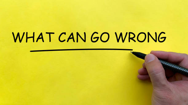 istock Hand writing What Can Go Wrong text on yellow cover board 2194210189