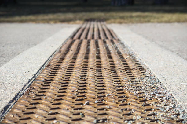istock .A rust-covered restored sewage channel between two concrete areas in a park with trees in the background. 2194210371