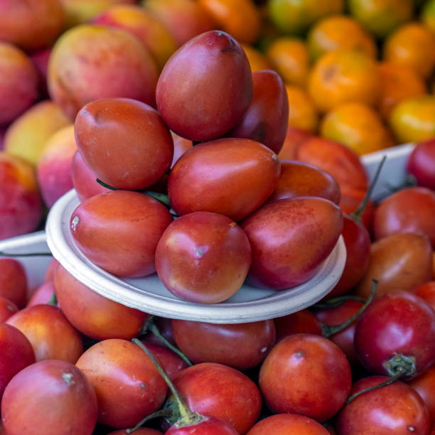 Organic tamarillo (Solanum betaceum) super food fruit on local fruit and vegetable market, Quito, Ecuador.