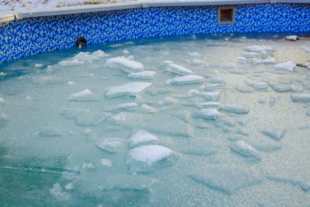 istock Frozen pool water with ice chunks and blue tiled surroundings in a cold winter setting 2194212255