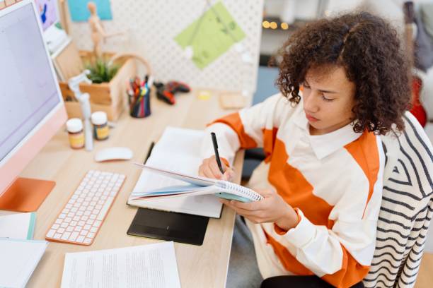 istock Top view of a young boy doing homework at home 2194213348
