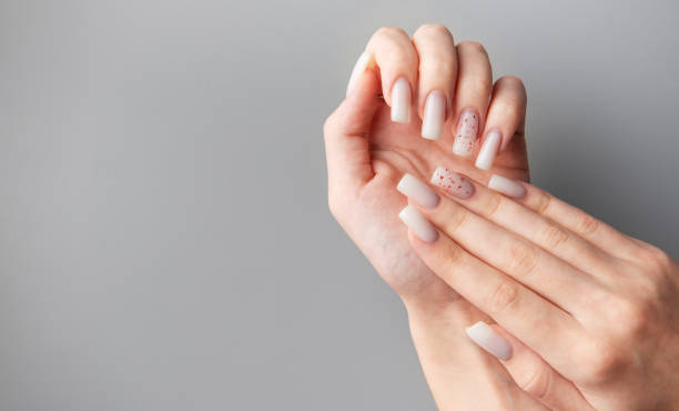istock Woman showing stylish white nails with glitter on grey background 2194213617