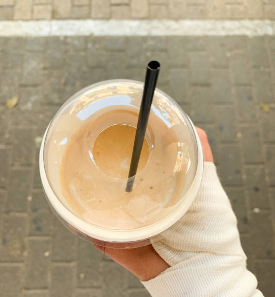 istock Top view of a cold coffee drink in a plastic cup with a black straw. 2194214206