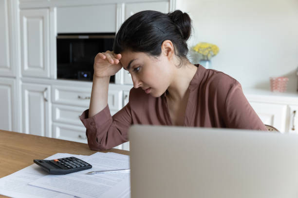 istock Close up unhappy Indian woman calculating bills, financial problems 2194214506