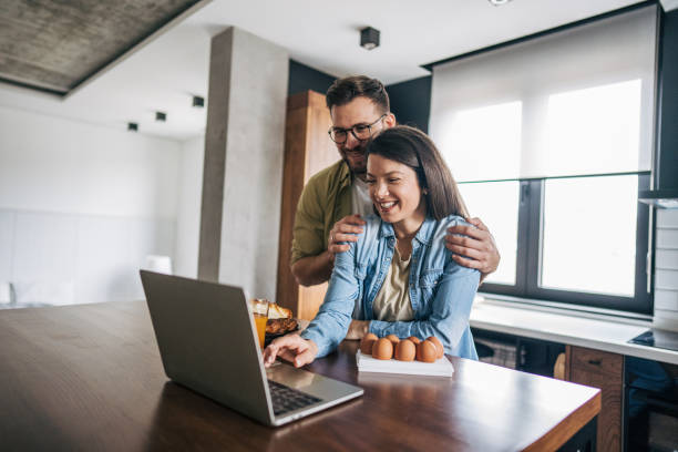 istock A quiet conversation with a pastry in the kitchen and a laptop 2194216361