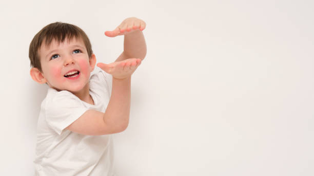 istock Smiling boy gesturing with hands on white background. Studio portrait with copy space. Child emotions and playful gesture concept. Kid aged three (three-year-old boy) 2194217674