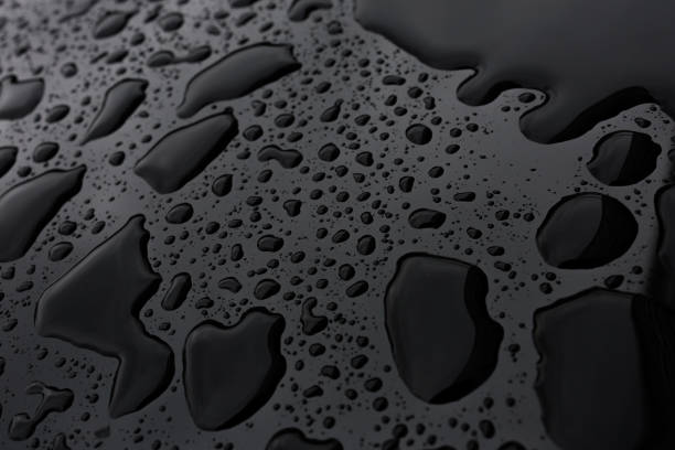 Close up of water drops on grey surface