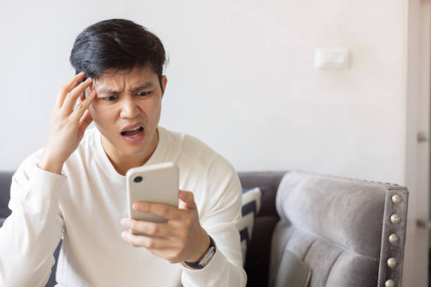 istock close up young asian man with shock and surprse emotion on face while hold smartphone to reading about fake news and rumor comment on social media application in home for people lifestyle concept 2194219591