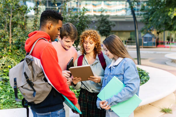 istock Group of students reviewing notes before an exam near university building 2194219759