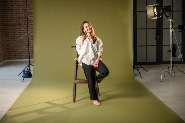 istock Barefoot woman posing with serene smile in studio. 2194219980