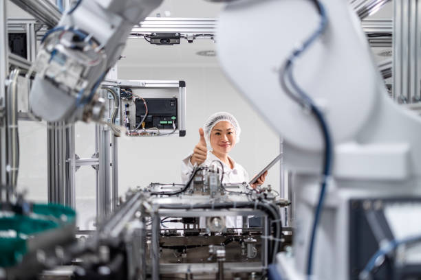 istock East Asian engineer working on robotic arm machine in advanced technology factory. 2194222766