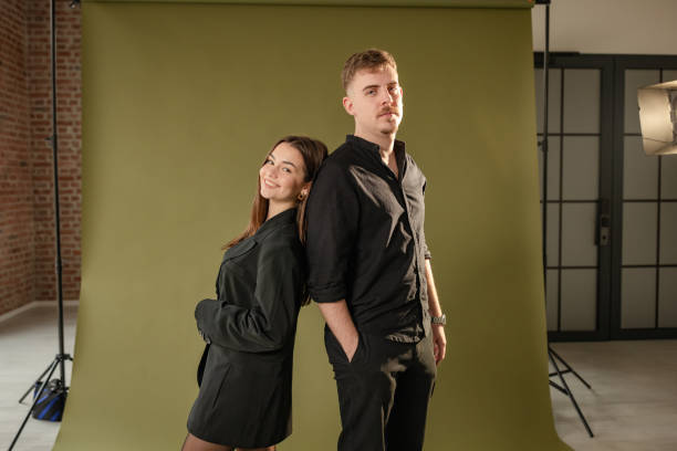 istock Fashionable couple posing in vibrant background studio 2194223045