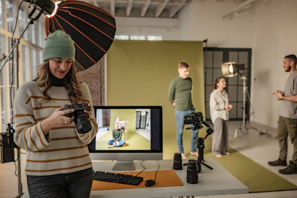 istock Female photographer reviewing camera in studio setup 2194223157