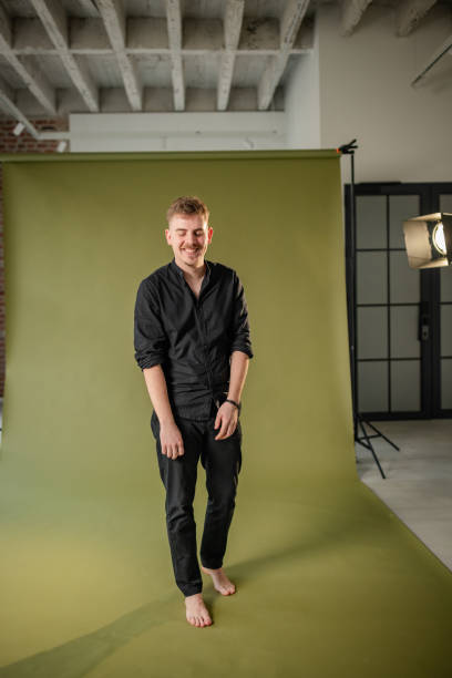istock Joyful man in modern studio, barefoot and laughing. 2194224010