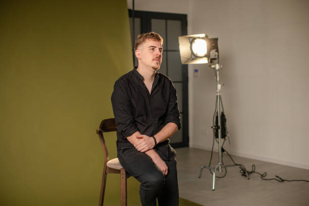 istock Man seated, looking away in a photography studio. 2194225081