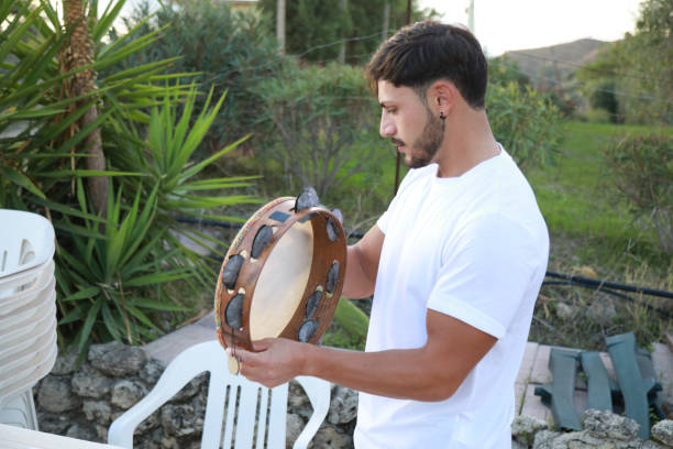 istock Happy Tambourine Player Performing in Fields 2194225433