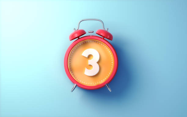 istock Red Alarm Clock with Orange Inside and White Digit 3 on Light Blue Soft Background 2194225657