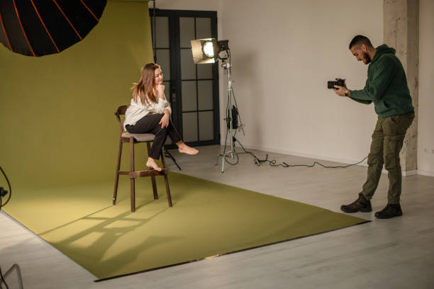istock Model sits barefoot on chair for studio photography shoot 2194225694