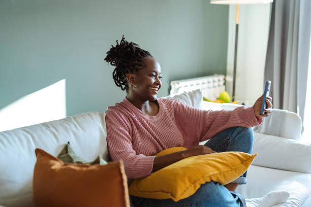 istock Woman enjoying a video call on her smartphone while relaxing at home 2194227309